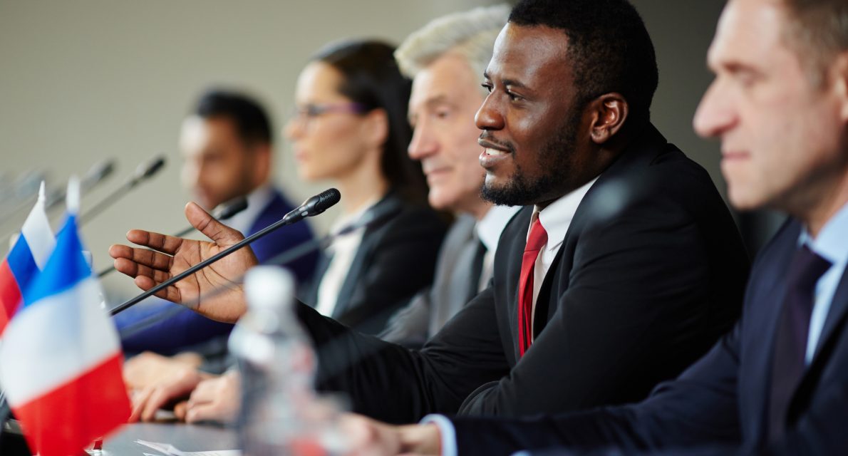 Young African-american politician explaining his opinion to audience during conference